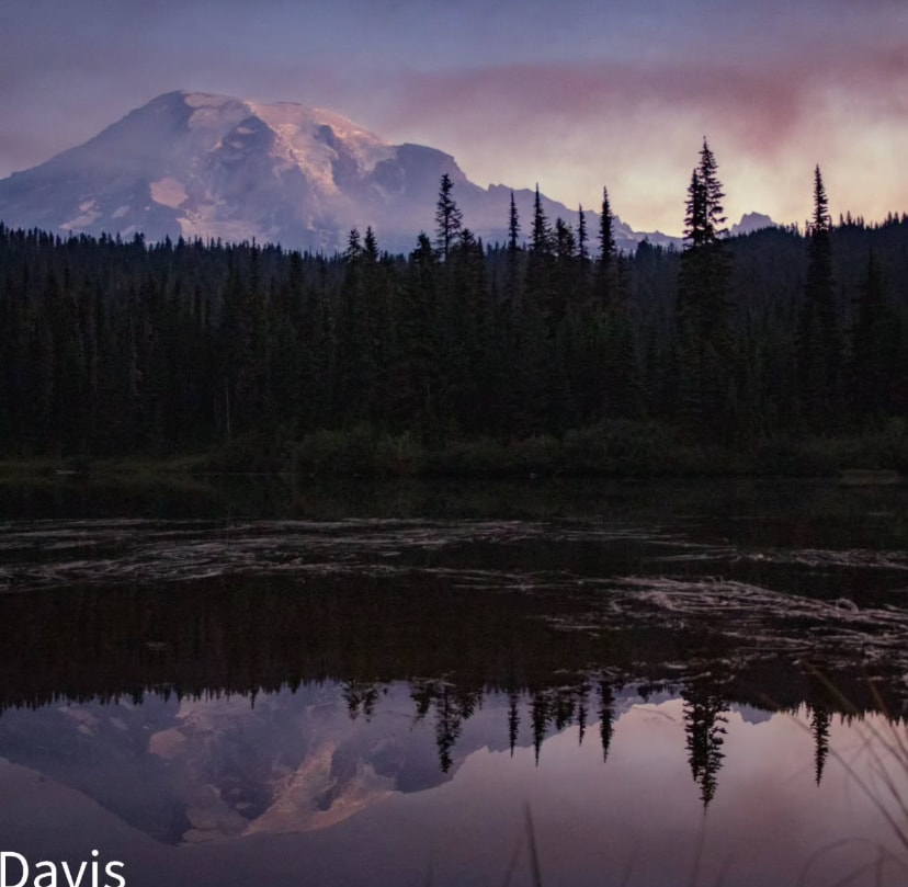 Mountain reflection in still water at dusk by Descendant Photography